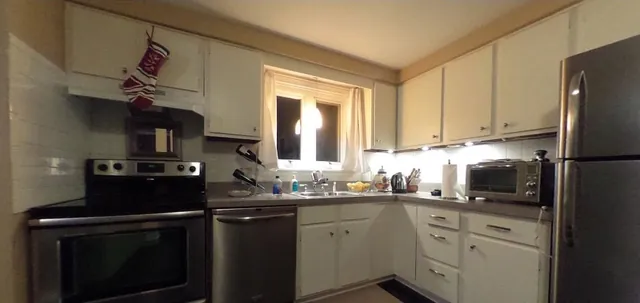 A condominium kitchen with stainless appliances
