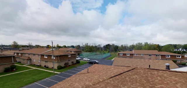Rooflines and parking of a residential complex seen from above