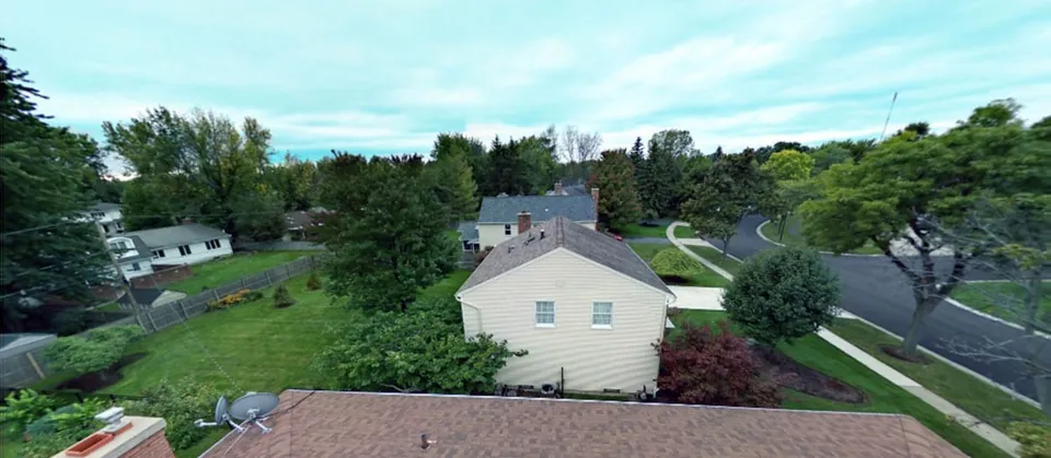 Aerial 360 degree panorama looking down over a Western New York home and its street