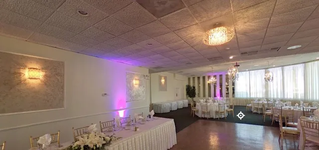 A set banquet hall with round tables and uplighting, photographed as a 360 panorama
